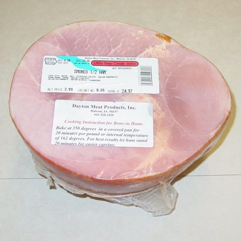 A piece of ham is wrapped in plastic and has a label on it