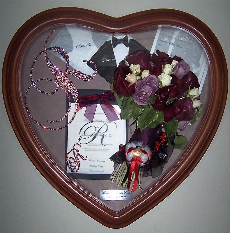 Heart-shaped shadow box with purple roses, ribbon, and a graduation plaque inside