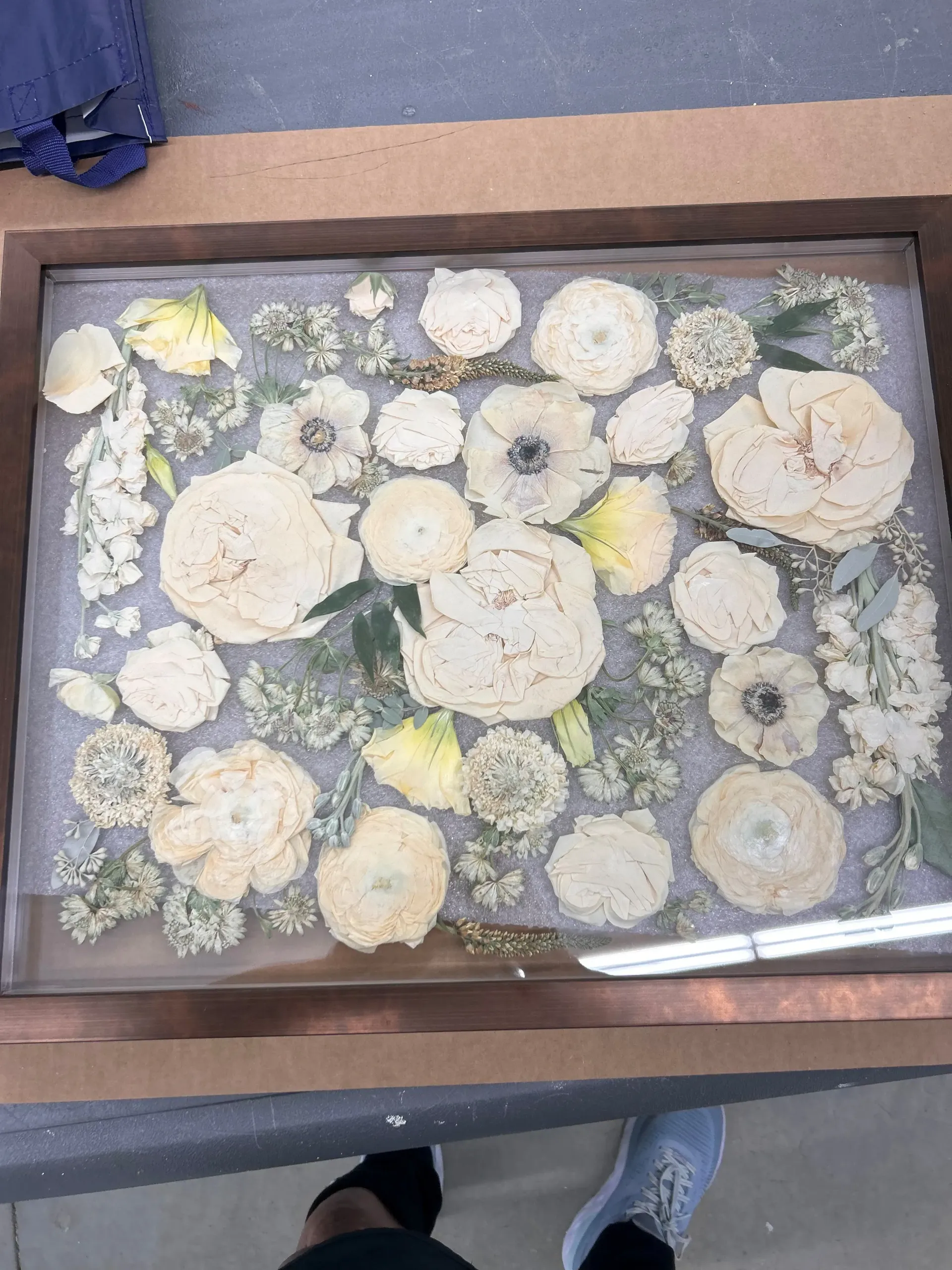 Tray of pale flower-shaped cookies or pastries dusted with powdered sugar, viewed from above