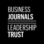 The Business Journals Leadership Trust logo in white text on a black background, separated by two horizontal lines.