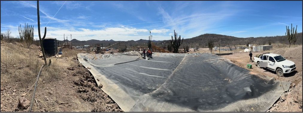 A white truck is parked on the side of a dirt road.