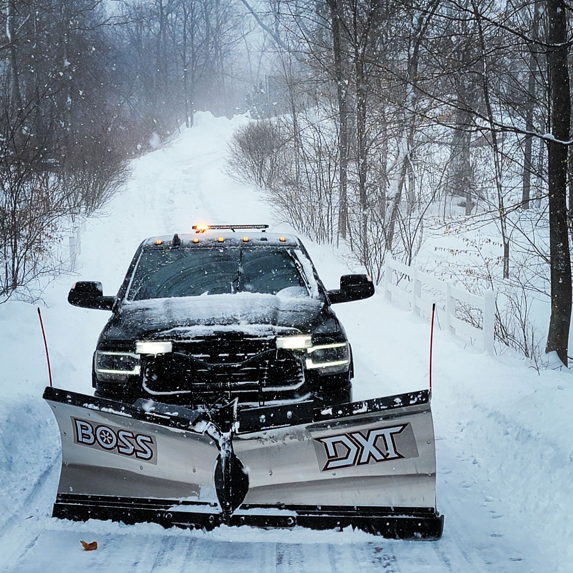 A truck with a snow plow that says boss on it