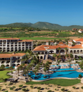 An aerial view of a resort with mountains in the background