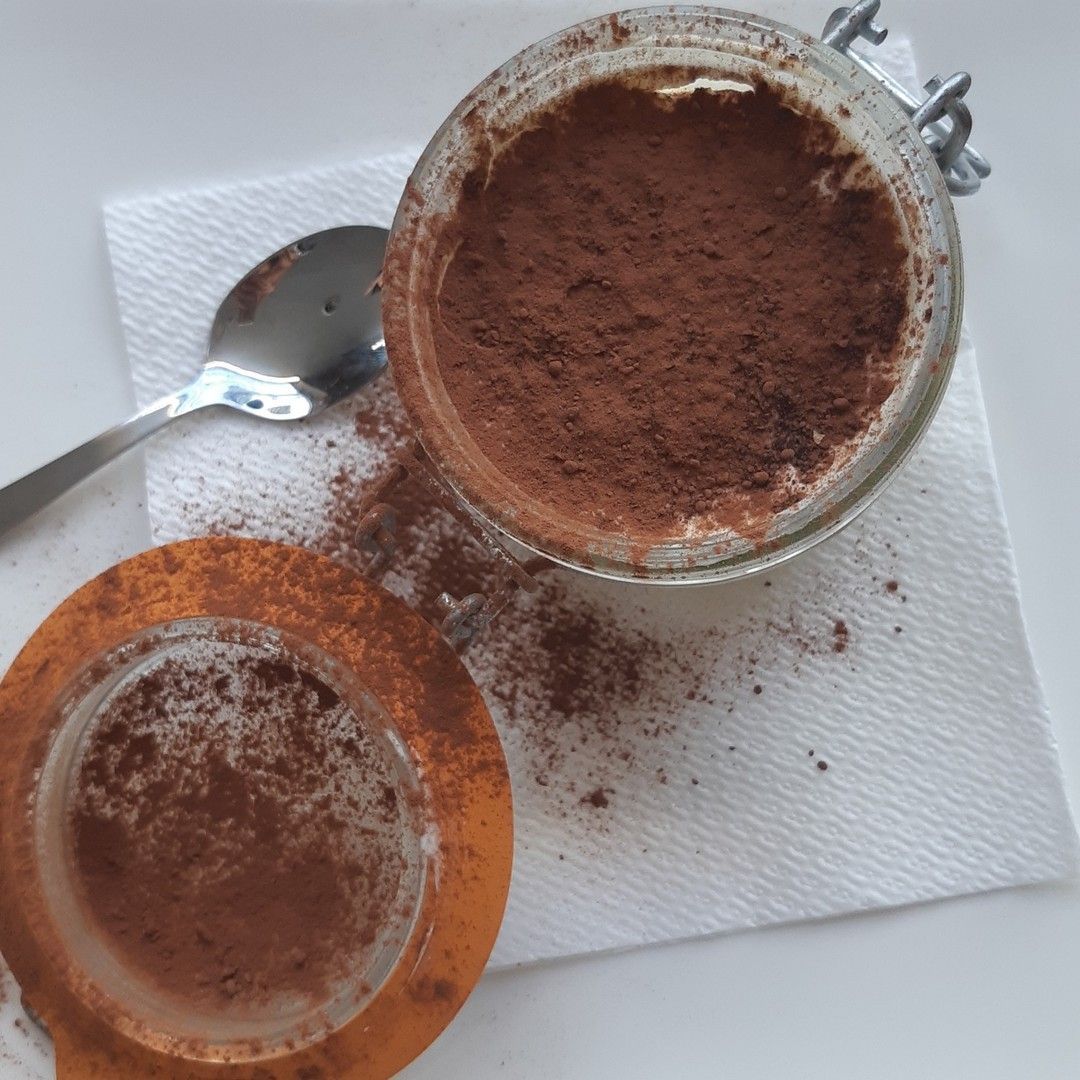 Due vasetti di cioccolato in polvere con un cucchiaio su un tovagliolo
