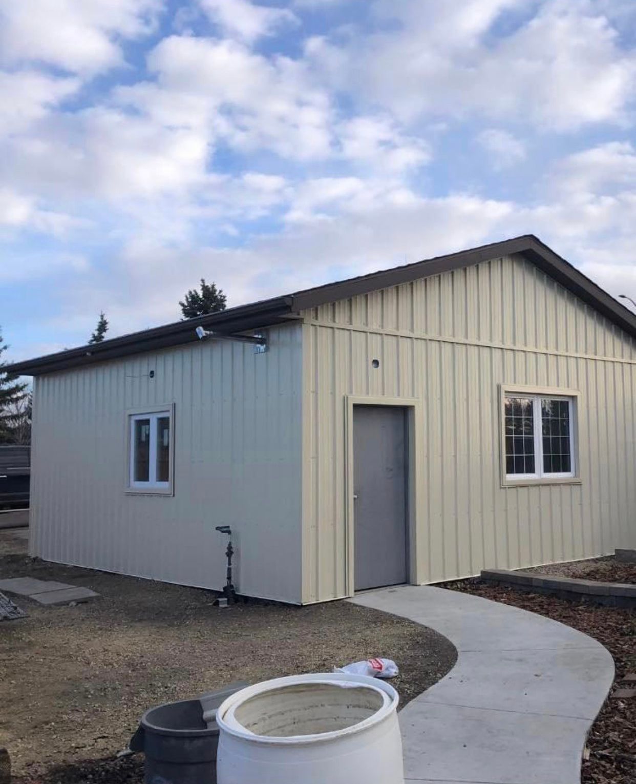 A small white building with a walkway leading to it