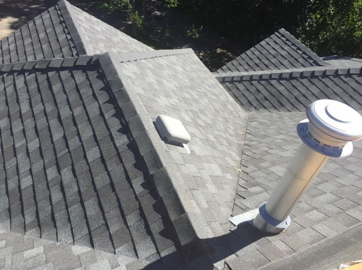 A roof with a chimney on the side of it