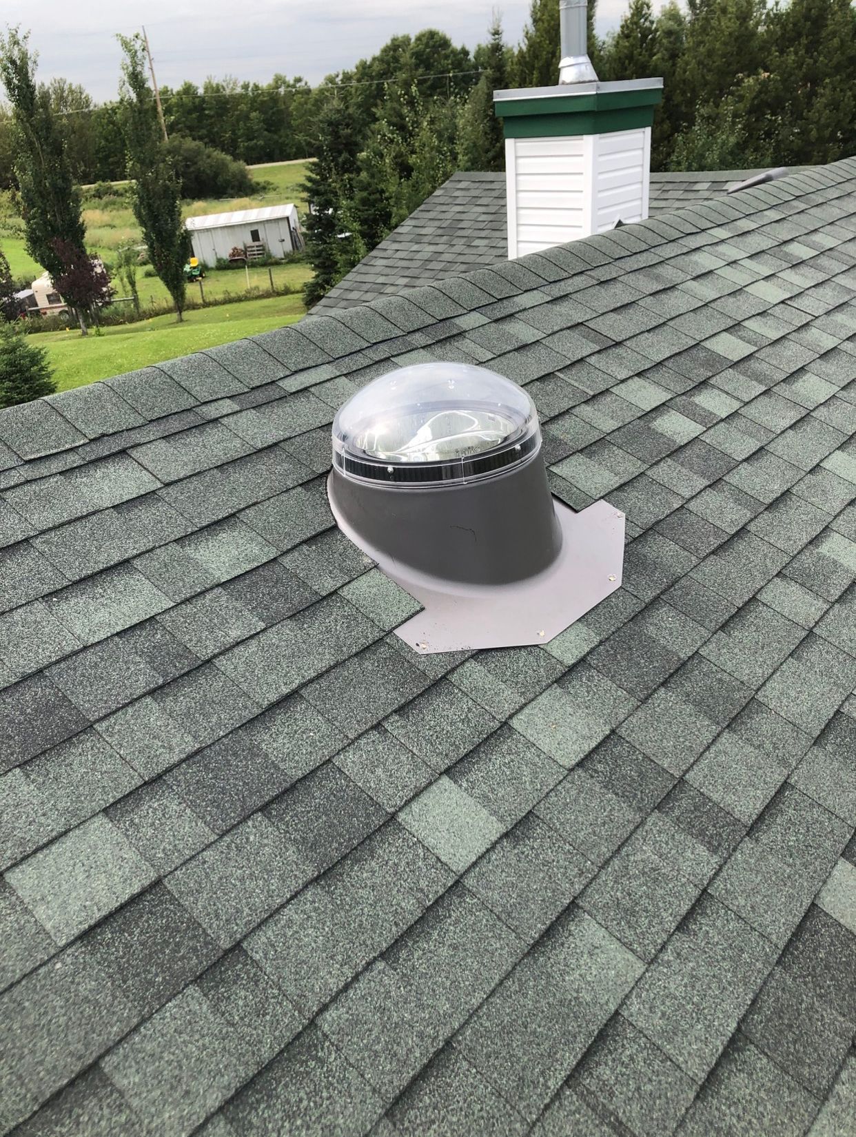 There is a skylight on the roof of a house.