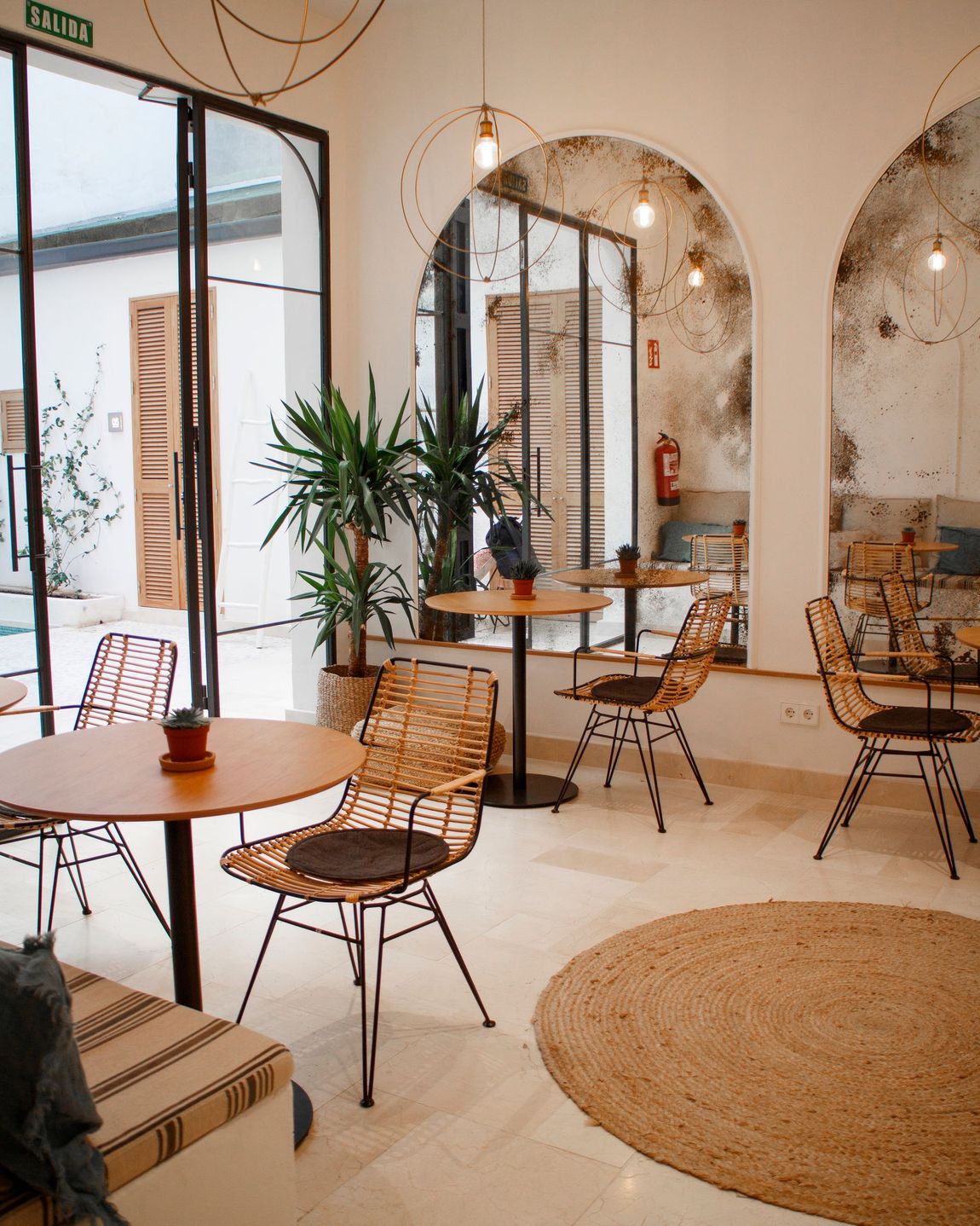 A room with tables and chairs in it and a rug on the floor.