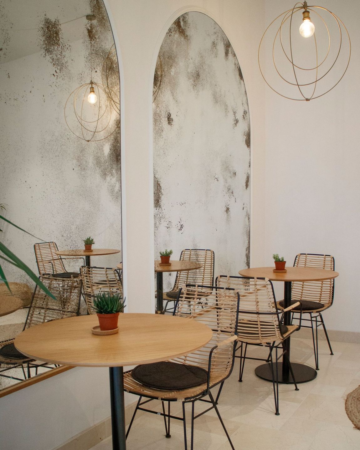 A room with tables and chairs and a mirror