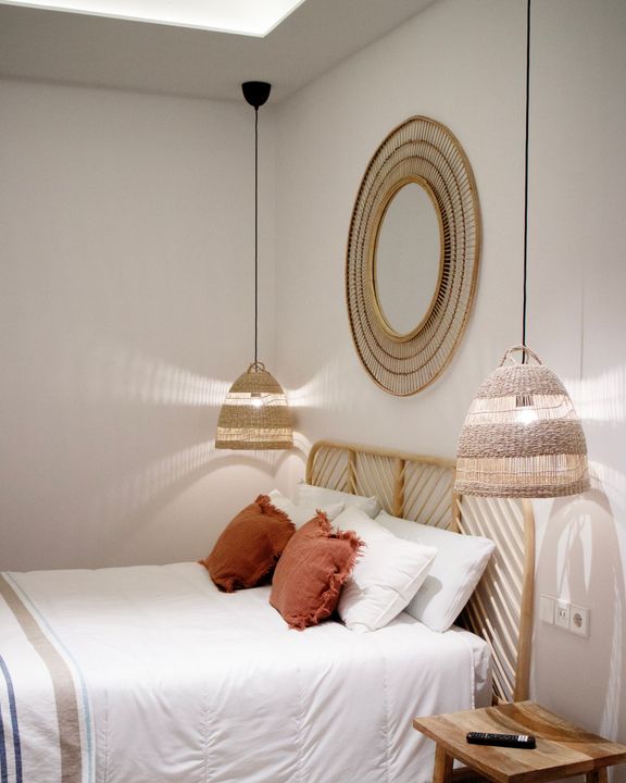A bedroom with a bed and a mirror on the wall