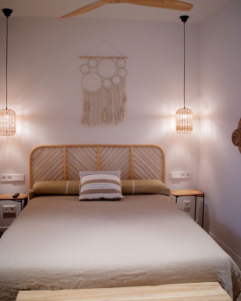 A bedroom with a bed and a ceiling fan