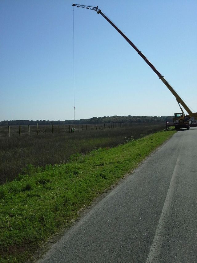 Installing Commercial Work Fence — Yulee, FL — Creative Services & Fence Company Inc.