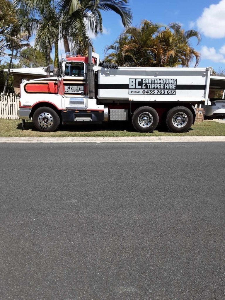 Dump Truck, Bed Raised, Unloading Dirt on a Construction Site — BC Earthmoving and Tipper Hire in Gympie, QLD