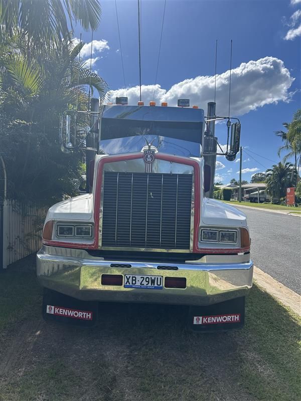 An Excavator Dumping Soil Into a Truck Bed — BC Earthmoving and Tipper Hire in Gympie, QLD