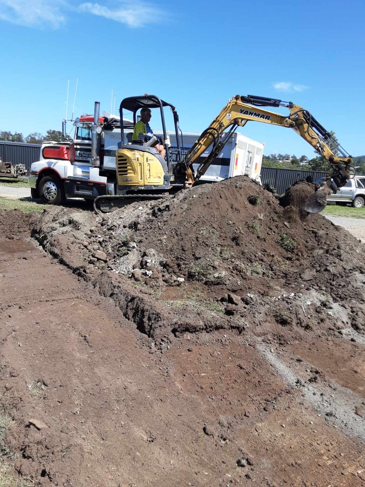 Yellow Excavator Demolishing a Building — BC Earthmoving and Tipper Hire in Gympie, QLD