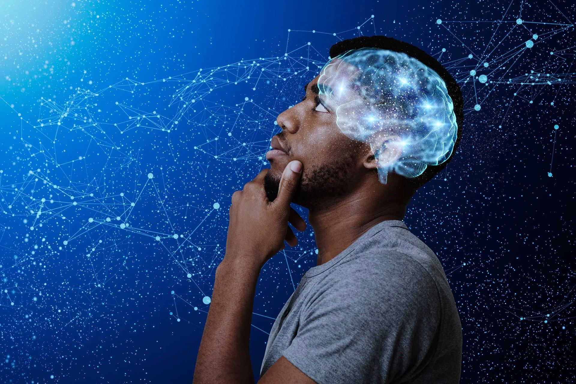 Therapist taking notes during a session; patient with head in hands in an armchair.