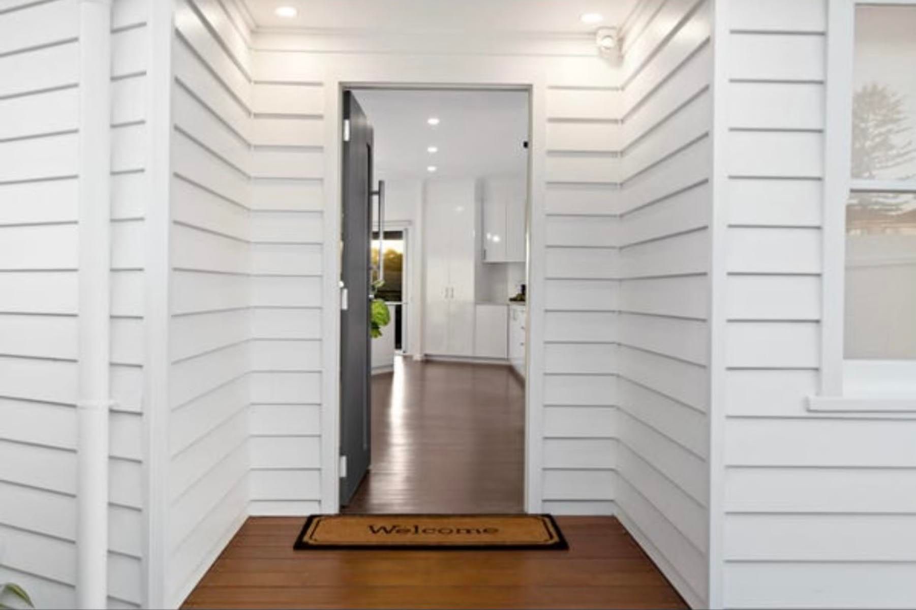 Newly painted front entryway with timber door and trims