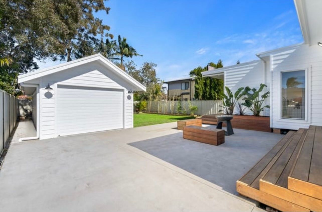 Clean repaint of garage and driveway area in modern tones