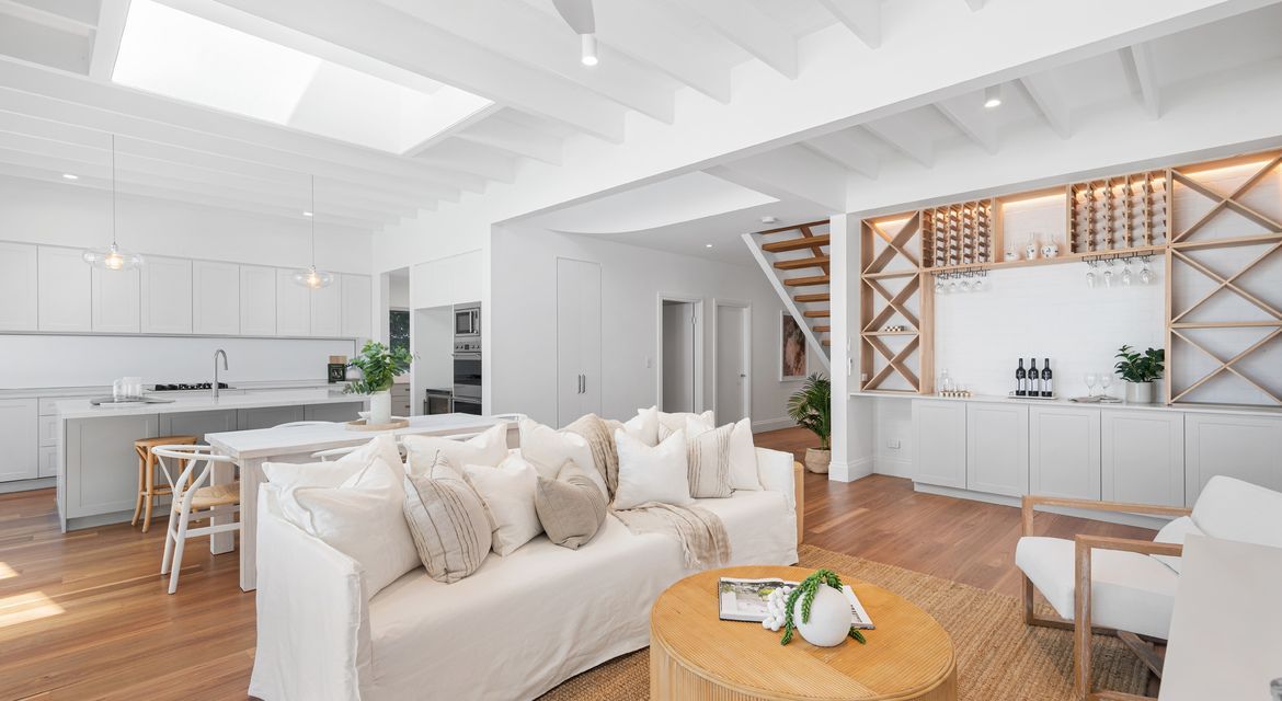 Freshly painted white living room with timber floors