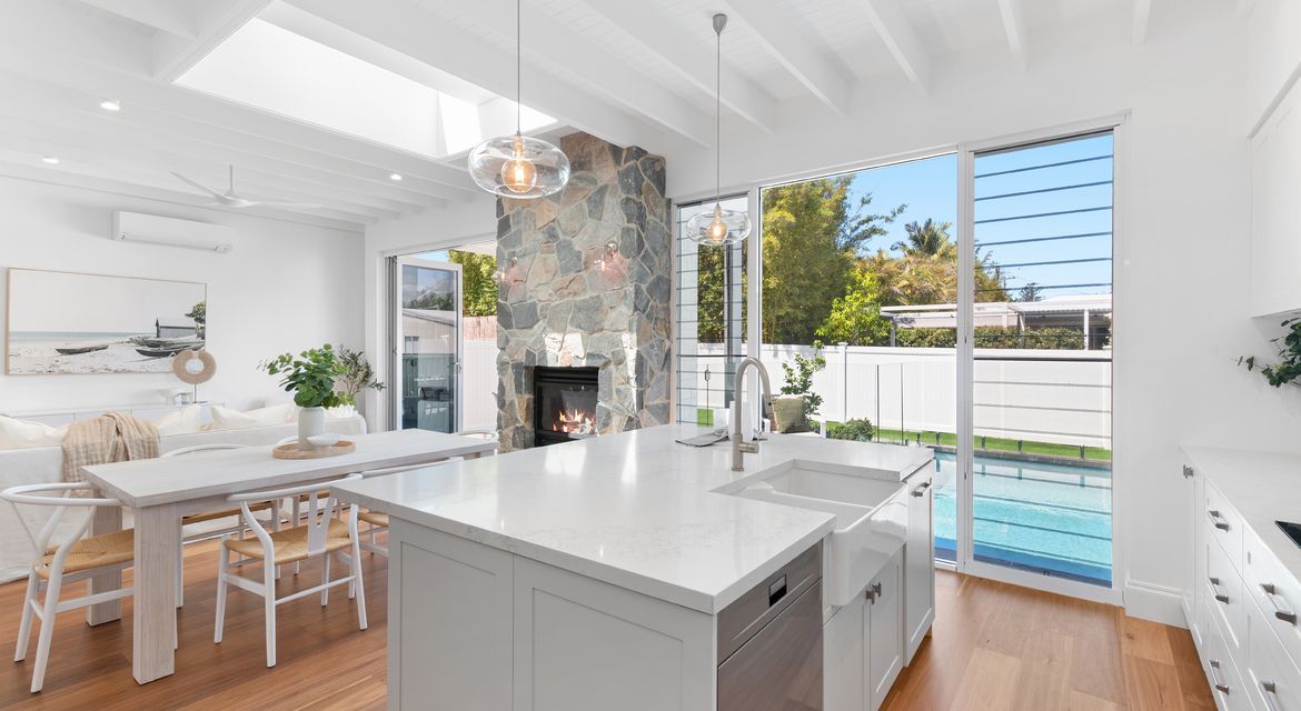 Freshly painted modern living room with white walls and timber floors