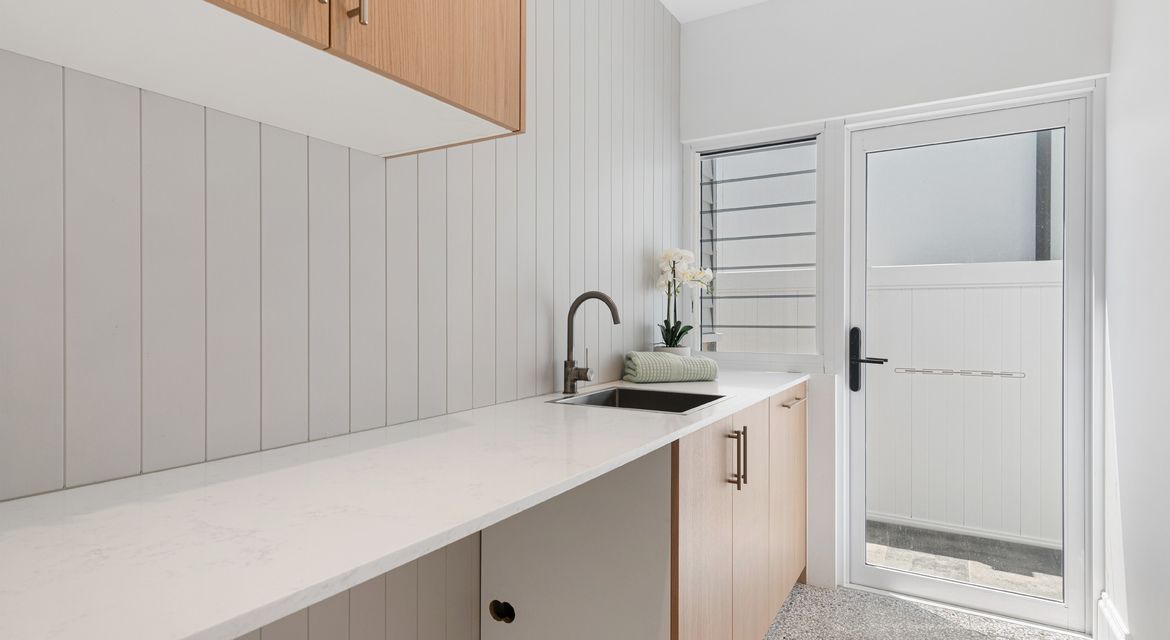 Laundry with moisture-resistant painted walls in soft beige