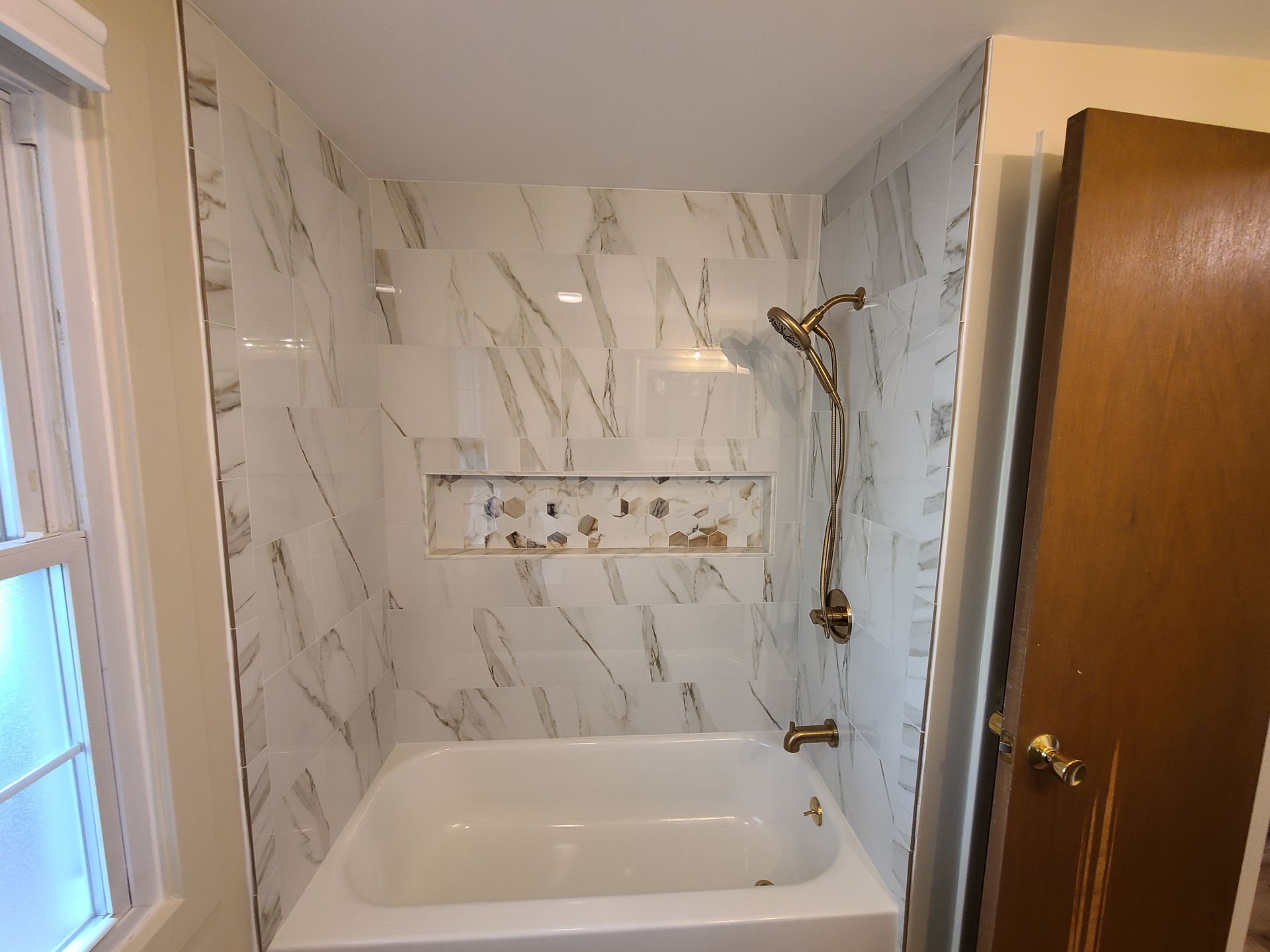A bathroom with a bathtub and a shower.