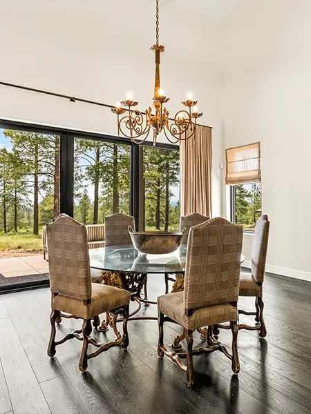 A dining room with a table and chairs and a chandelier.