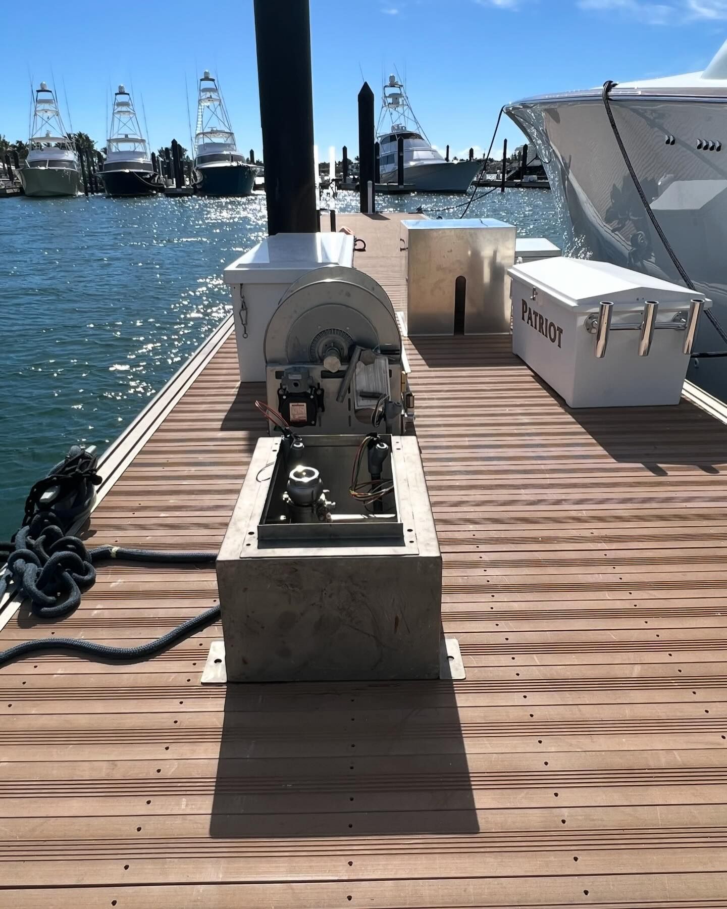 Construction worker holding electrical wires, near metal framing in a building.