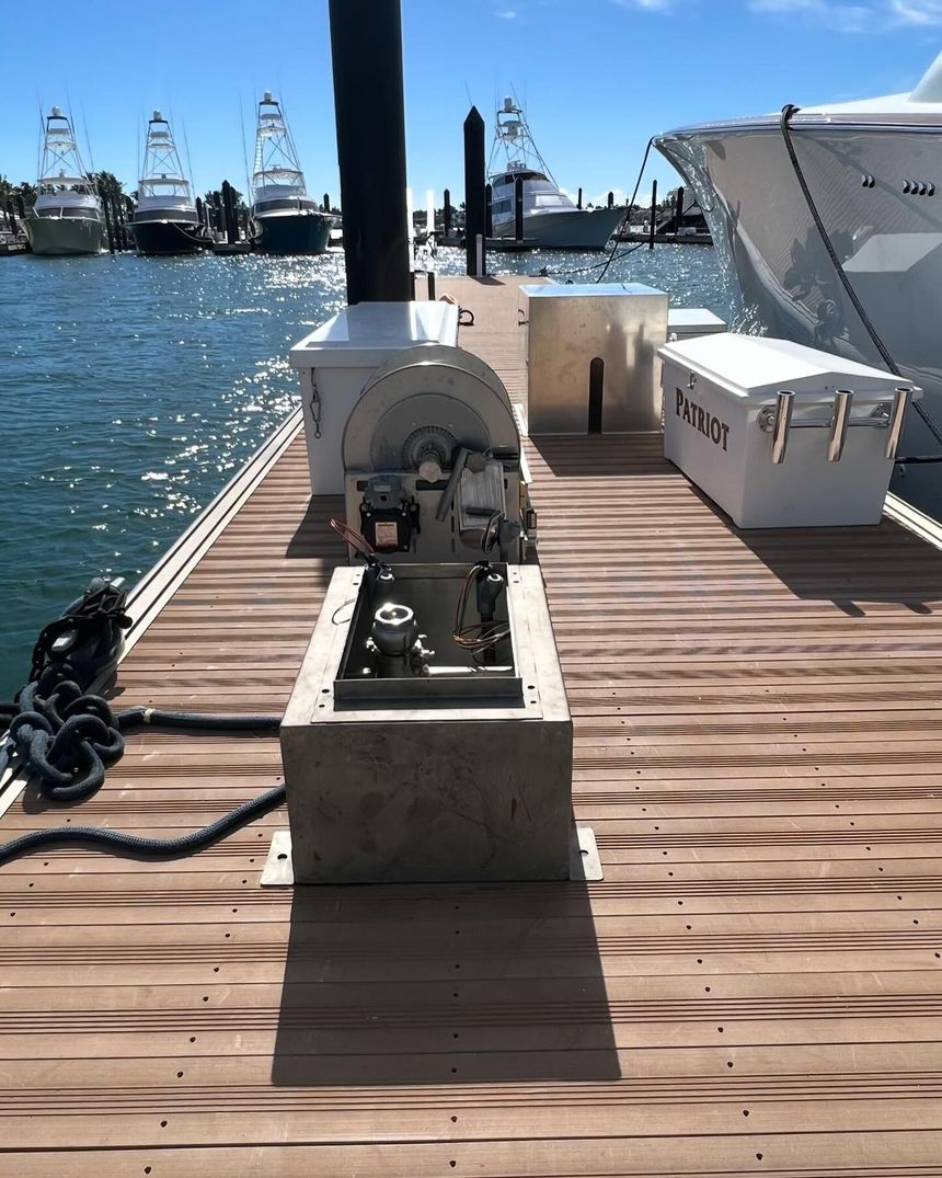 Construction worker holding electrical wires, near metal framing in a building.