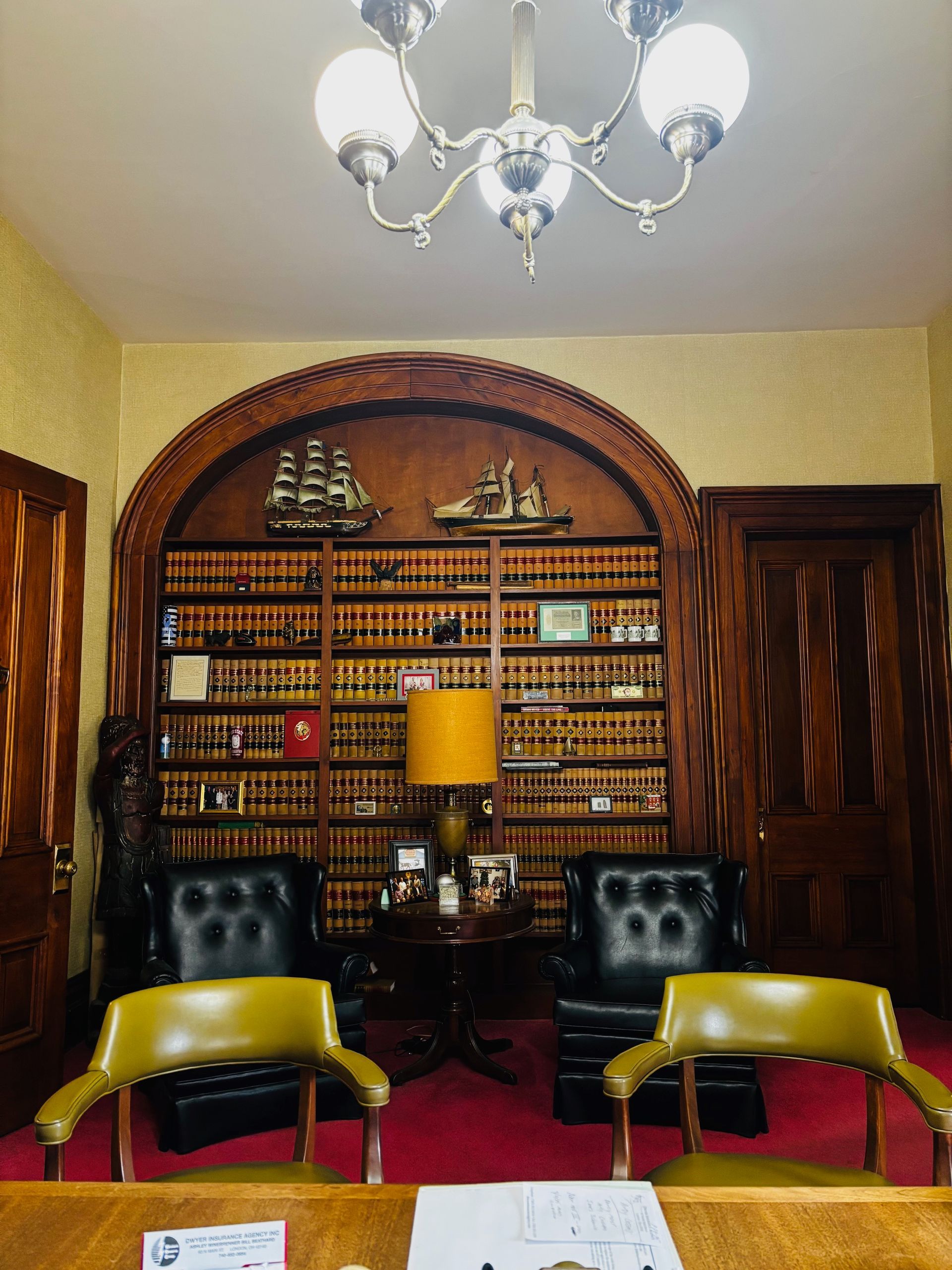 A room with two chairs a table and a lamp