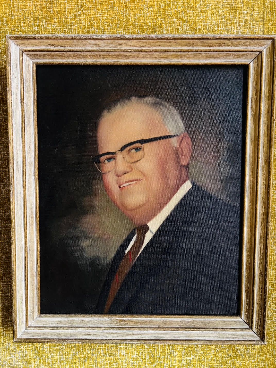 A framed portrait of a man in a suit and tie