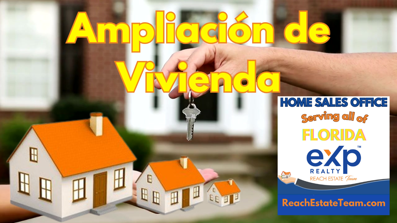 A person is holding a key in front of a model house.