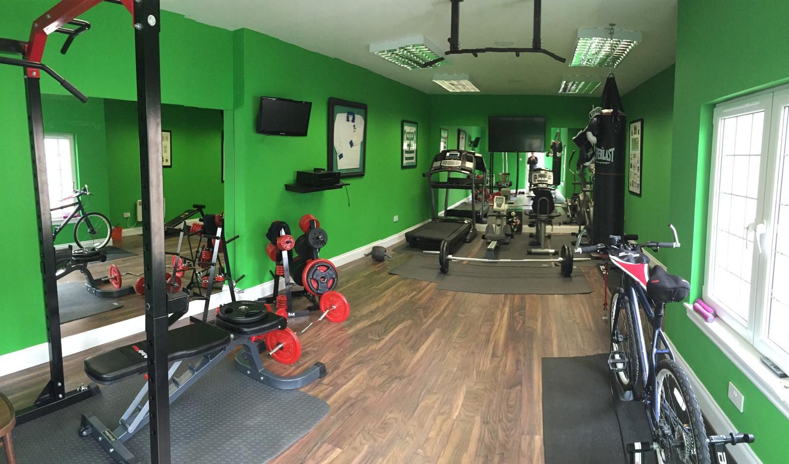 Garden Gym With Mirrors and Open Training Space Bright garden gym with exercise bike, wall mirrors, sockets and open training space designed for home workouts
