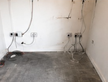 Inadequate Power for Garden Gyms Unfinished garden room wall with limited sockets and exposed cables showing inadequate power for a garden gym