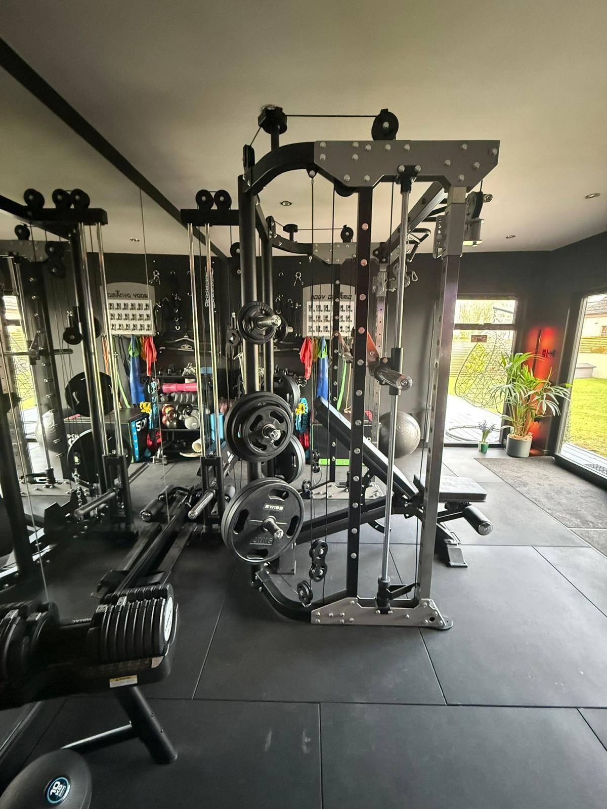 Private Garden Room Gym From Oakspan Private Oakspan garden room gym with squat rack, mirrors, treadmill, rubber flooring and full-width garden doors
