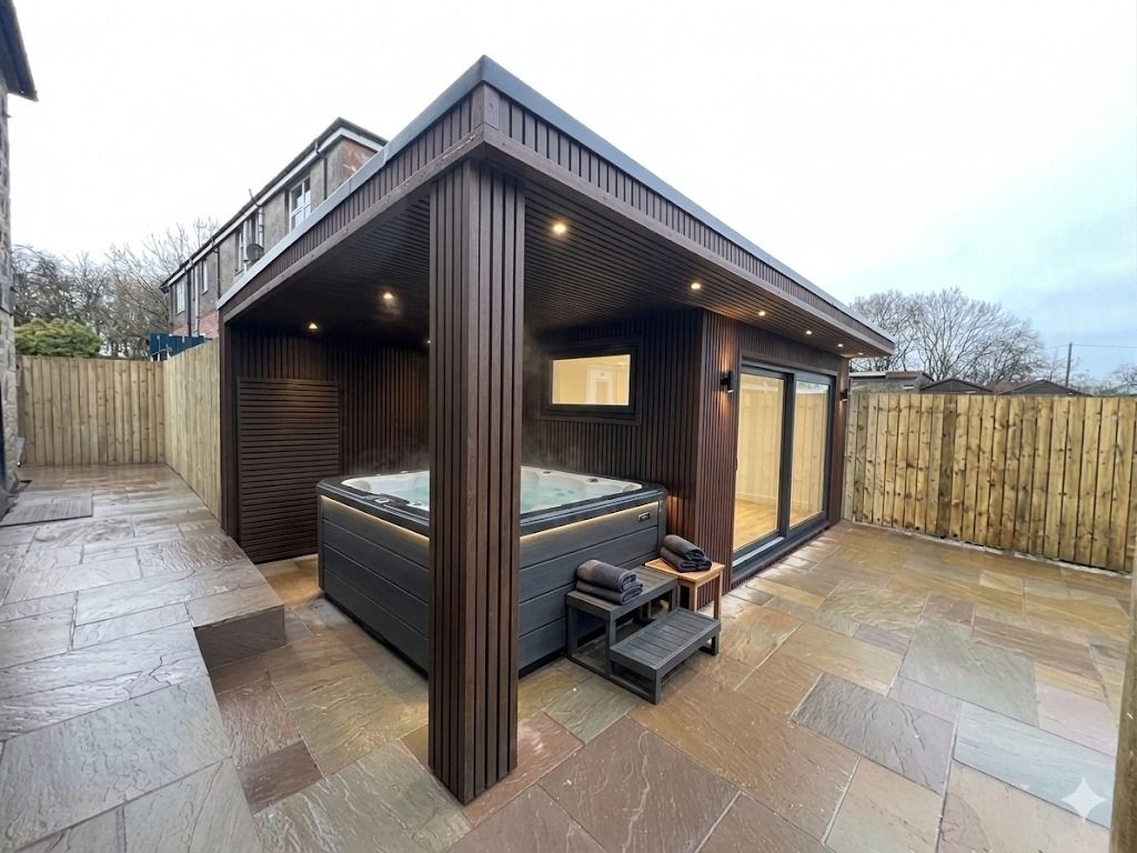 Architectural Oakspan garden room with premium cladding and outdoor living design