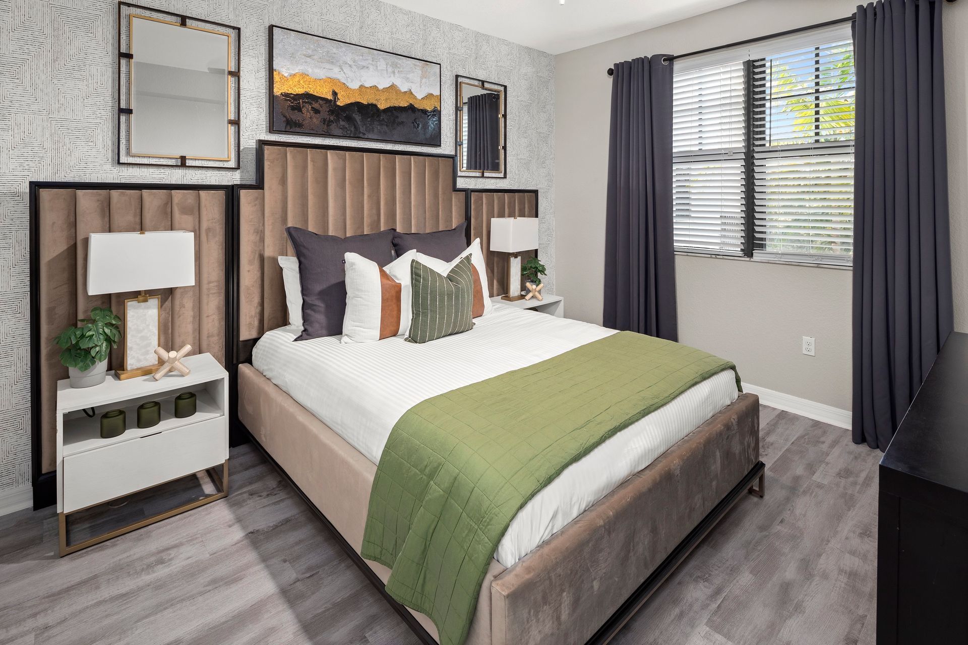 Bedroom with bed, night stand, wall art, and window at Mosaic at Miramar Town Center.