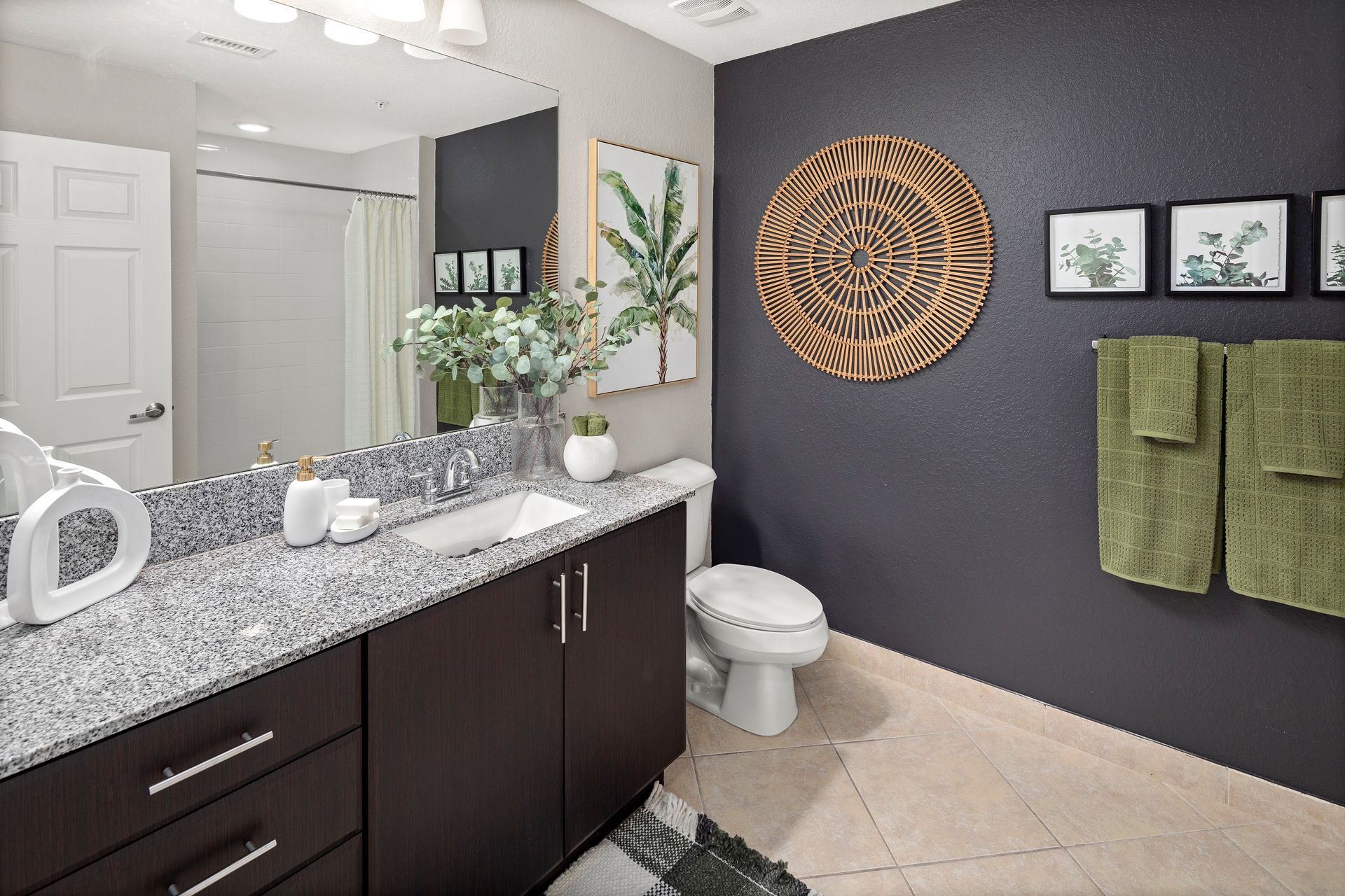 Resort-style bathroom with wall art at Mosaic at Miramar Town Center.