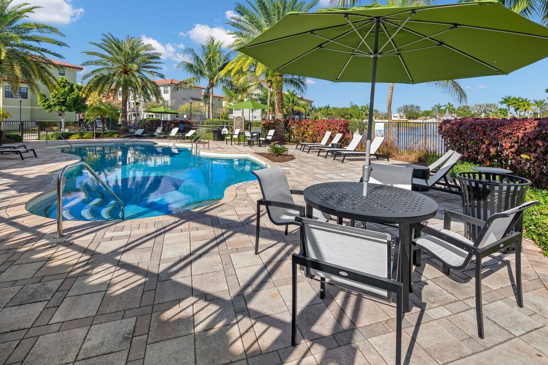 Apartment community pool at Mosaic at Miramar Town Center with poolside lounge.