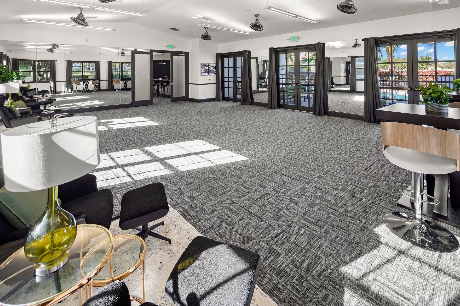 Apartment community conference at Mosaic at Miramar Town Center with chairs and tables.