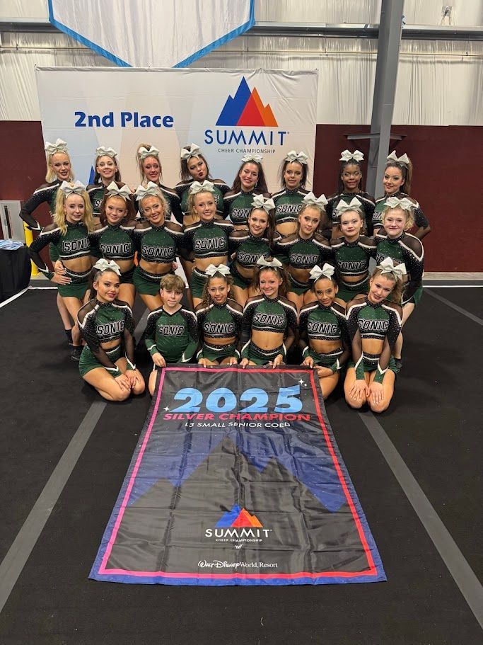 Cheerleading team in green uniforms holds a banner for the Summit Championship 2025, 2nd place.