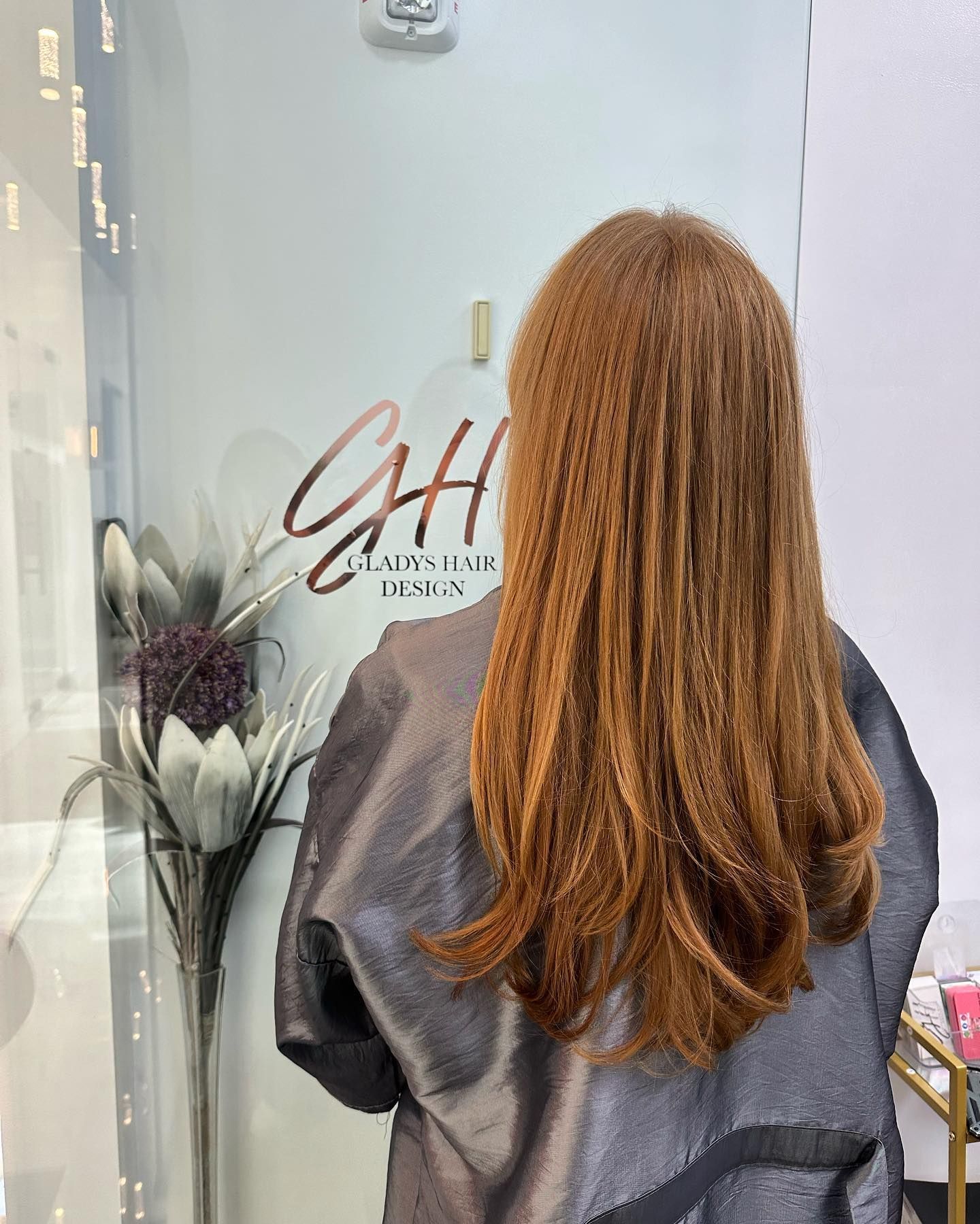 Back view of light brown curly hair at CAH Salon.