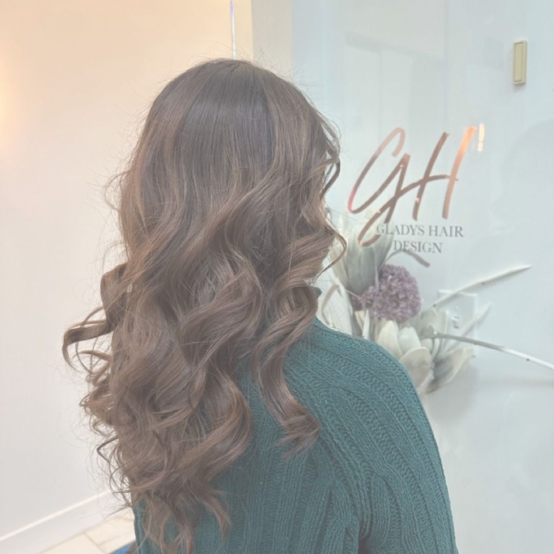 Soft brown curls hairstyle at CAH Salon.
