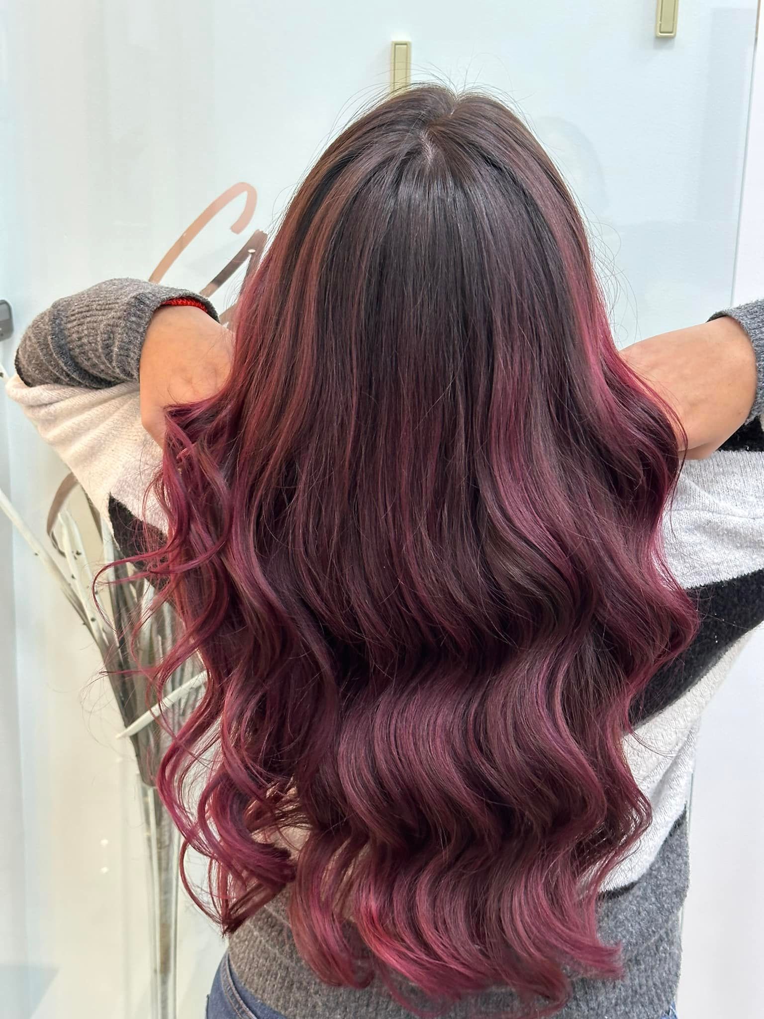 Red ombre hair color styled at CAH Salon.