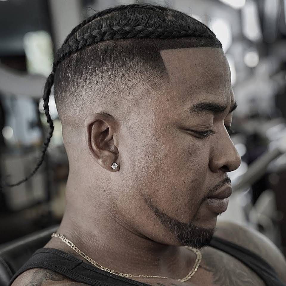 a man with a braided haircut and a beard