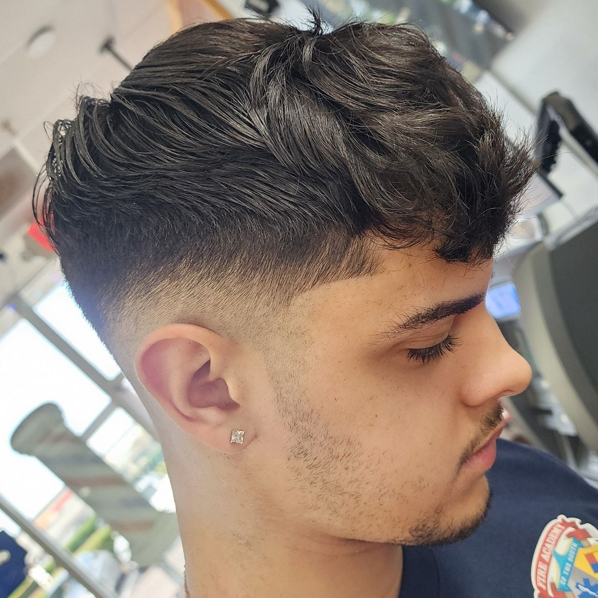a close up of a man 's head with a fade haircut .