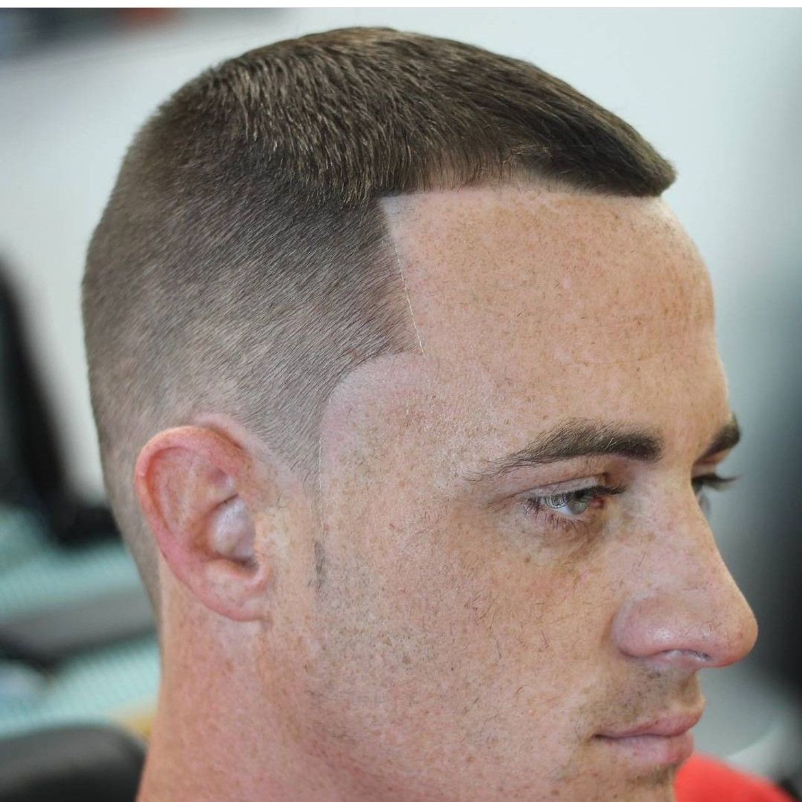 a close up of a man 's face with a very short haircut