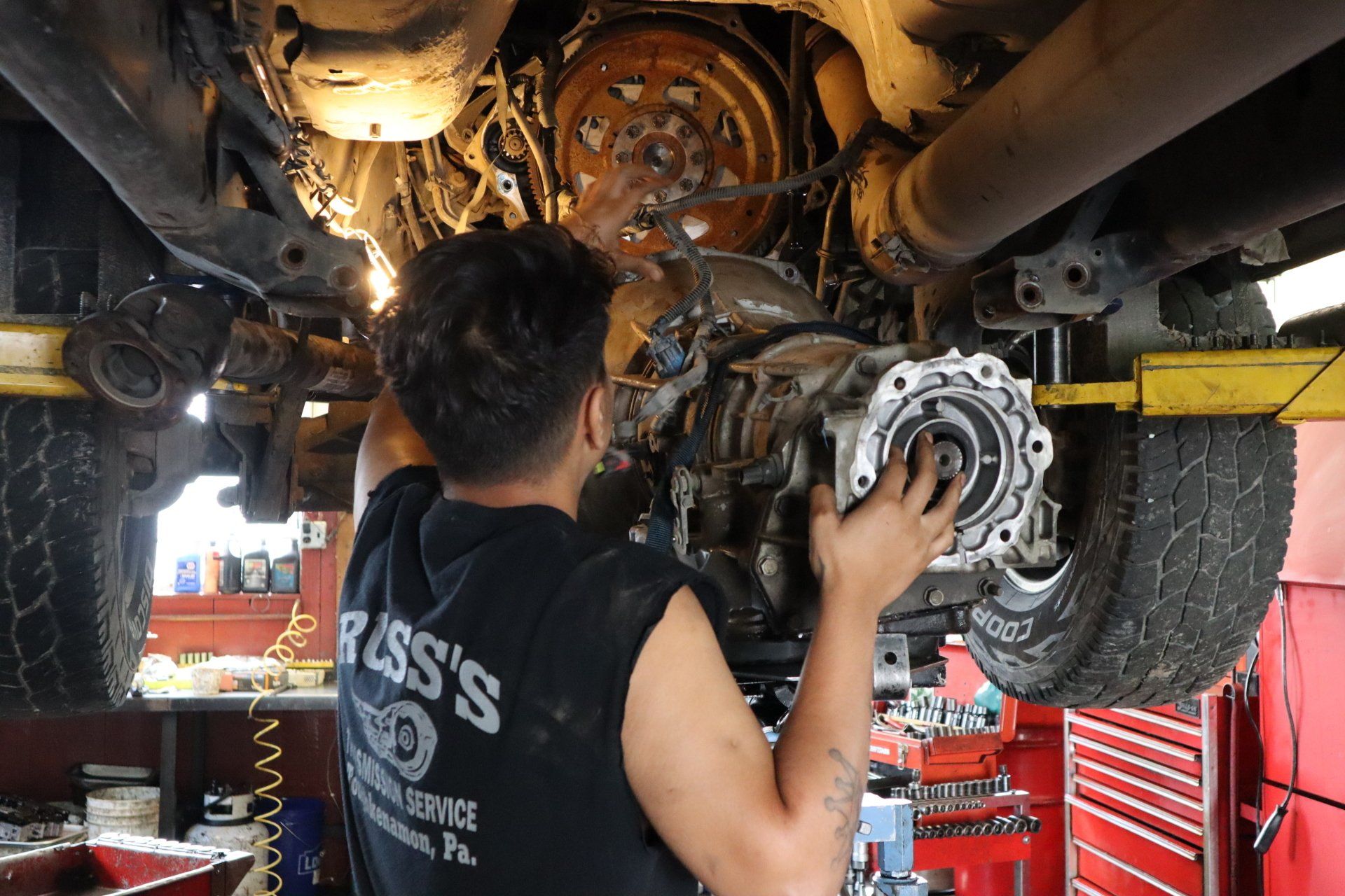 Transfer Case Repair — Mechanic Repairing A Lifted Car in Toughkenamon, PA