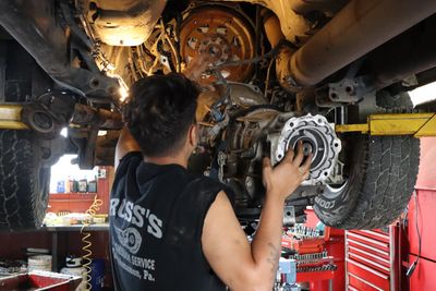 Transfer Case Repair — Mechanic Repairing A Lifted Car in Toughkenamon, PA