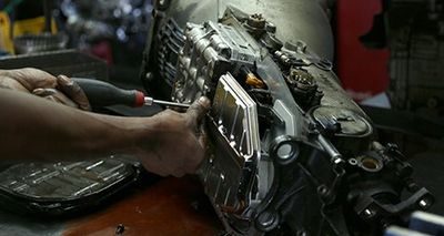 Auto Repair Shop — Mechanic Working On Car Transmission in Toughkenamon, PA